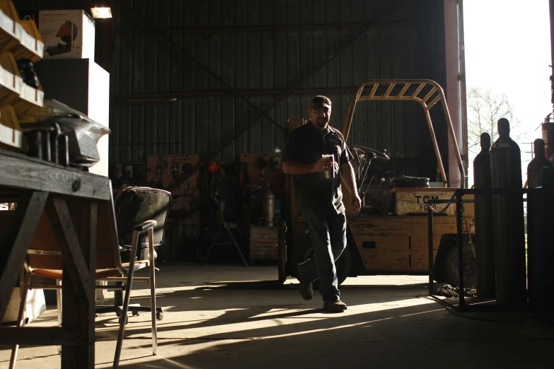 a man that is standing in a garage