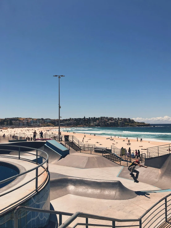 many people are at a skate park by the beach