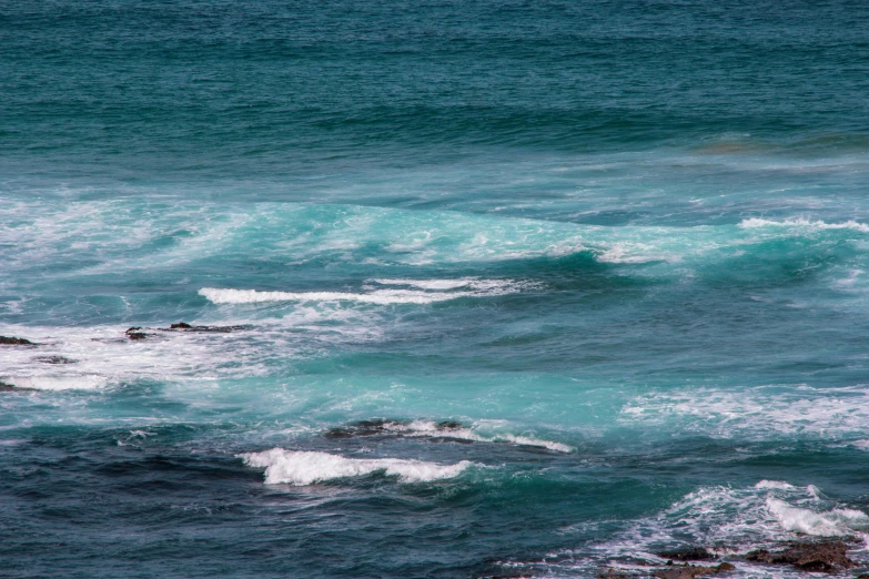 two men are surfing the waves in the ocean