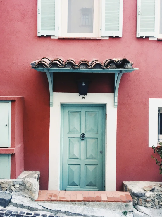 the door is closed on this pink building