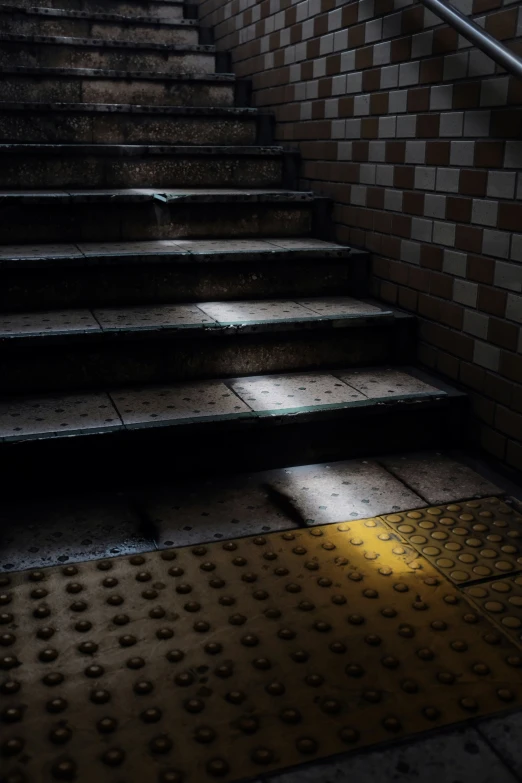 a stairway lit up by a bright spot on the floor