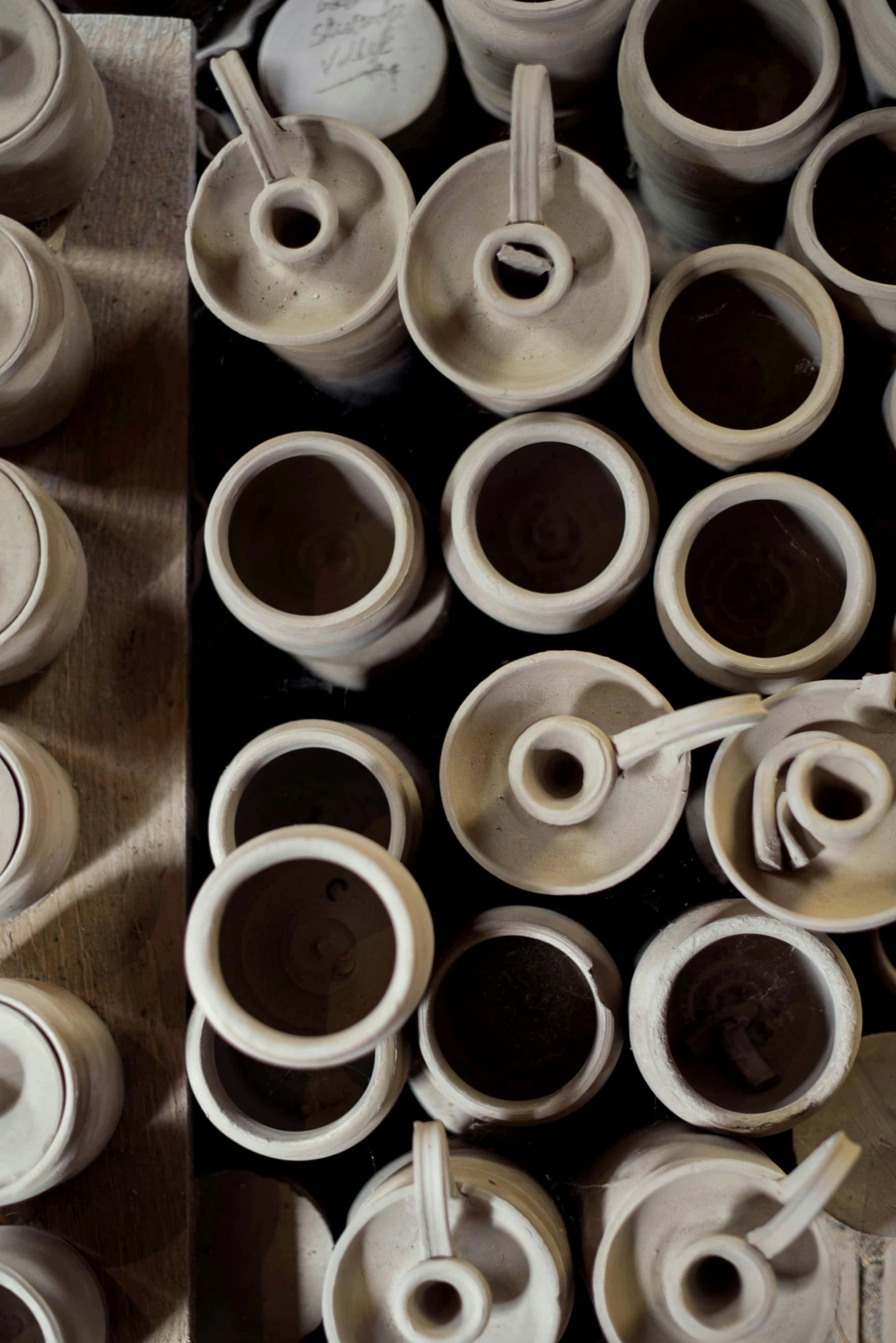 this is a big display of pottery with cups on it