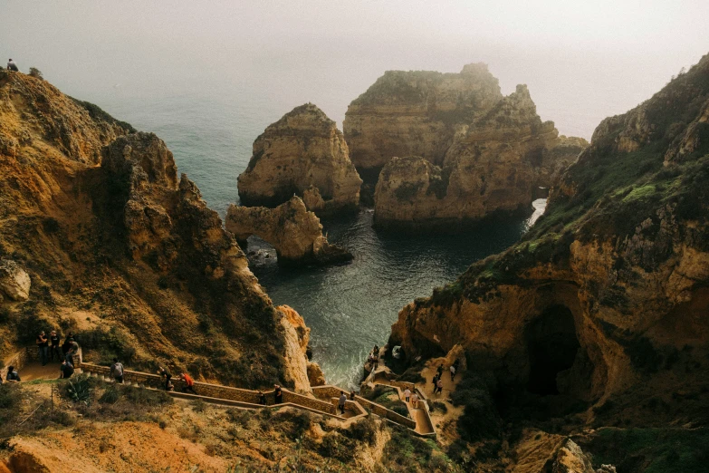 the ocean is surrounded by some large rocks