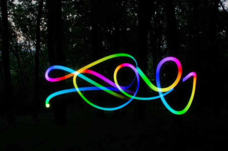 a multi - colored light painting on the ground at night