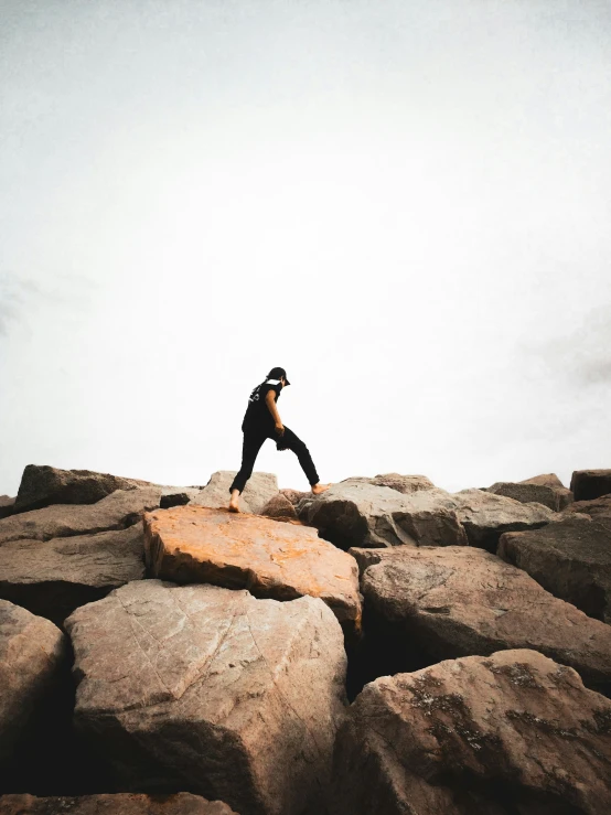 a man standing on top of large rocks