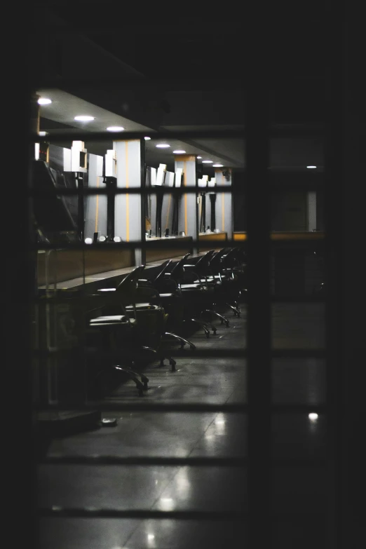 an empty room with chairs at the tables and lights all around