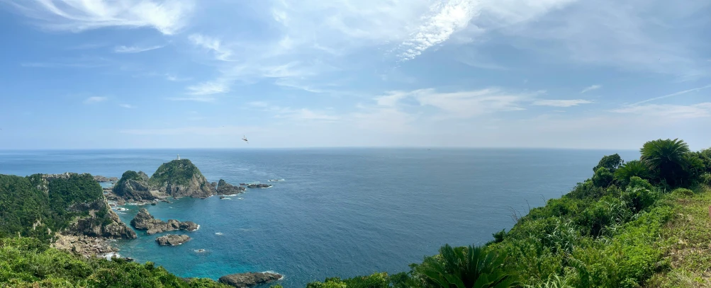 view of blue water from a very high cliff