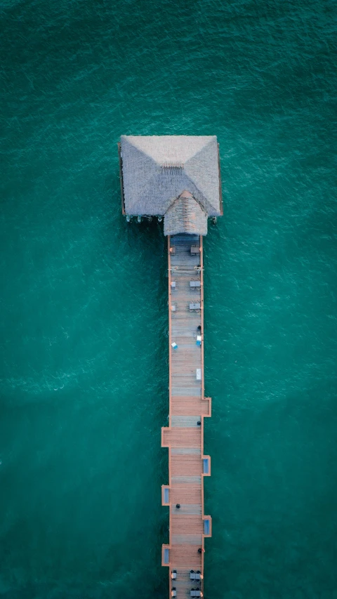 an aerial view of a dock, with one pier in the water