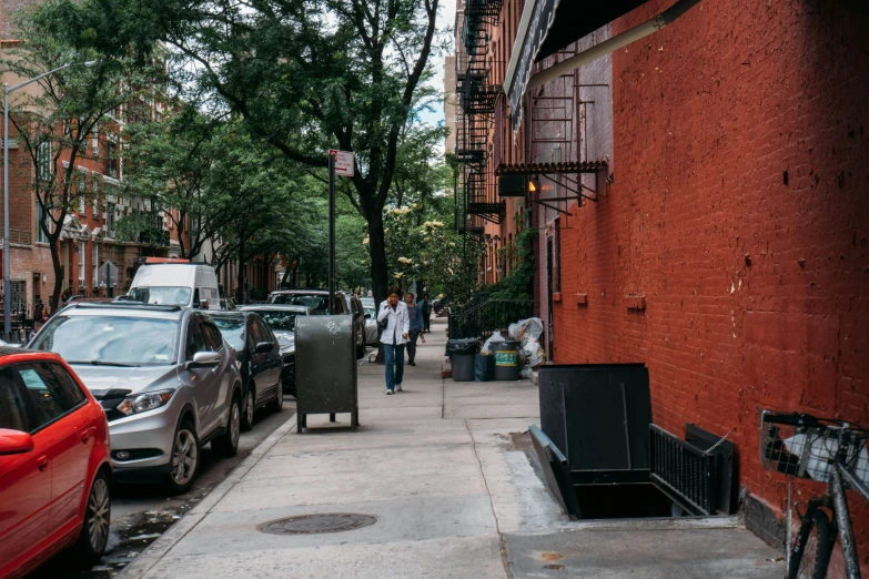 a couple of people walking down a sidewalk