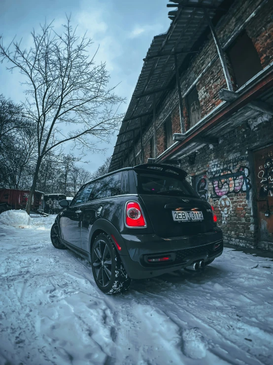 an automobile is parked in front of a brick building