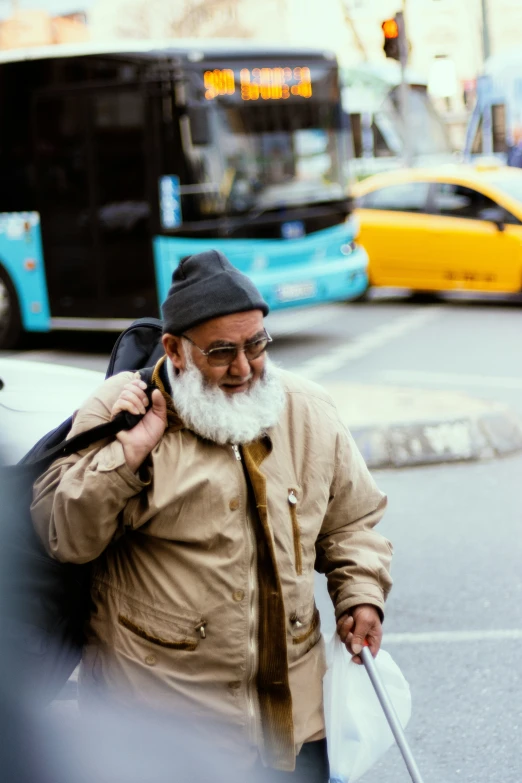 a man with a long white beard walking down the street