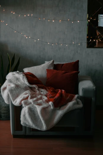 a couch with red and white pillows on top of it
