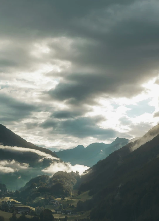 a green valley with hills and clouds