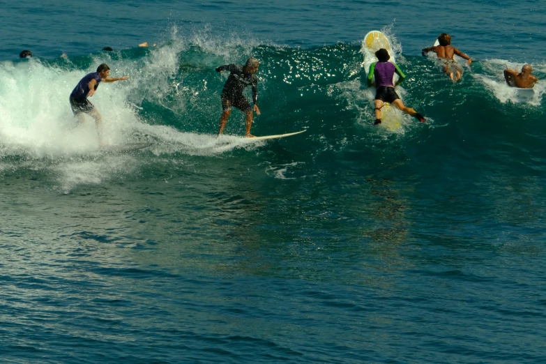 a group of people surfing on the ocean