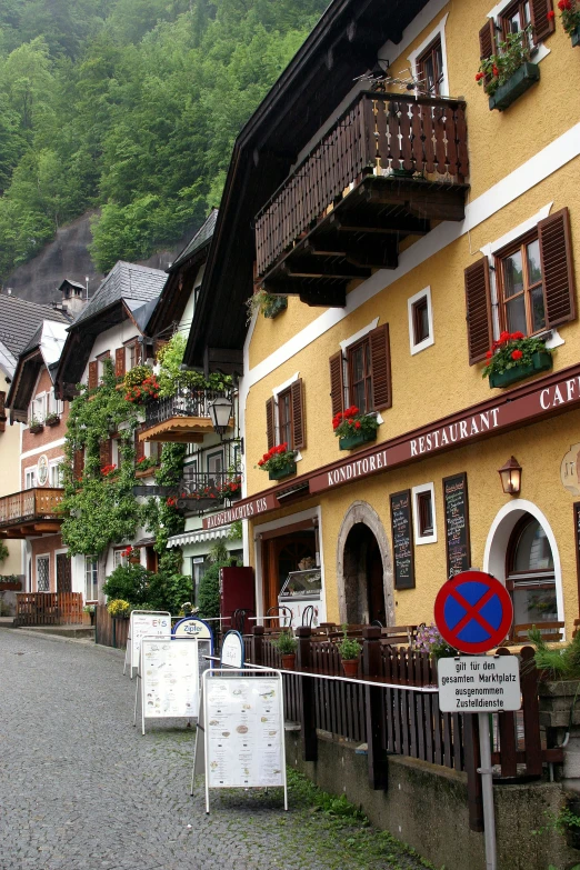 some very pretty buildings with big windows near a hill