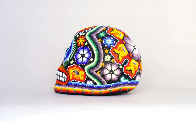 a colorful, patterned hat is on a white table