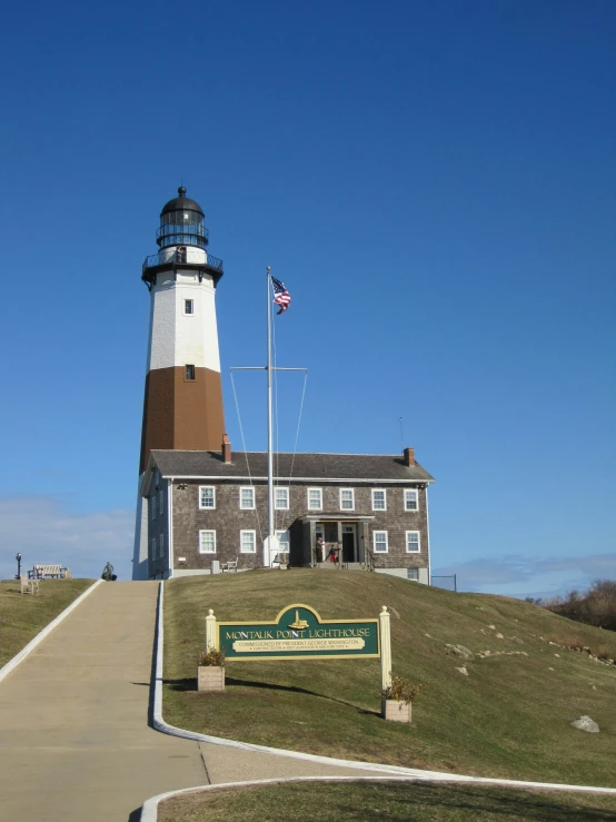 the lighthouse sits on top of a hill