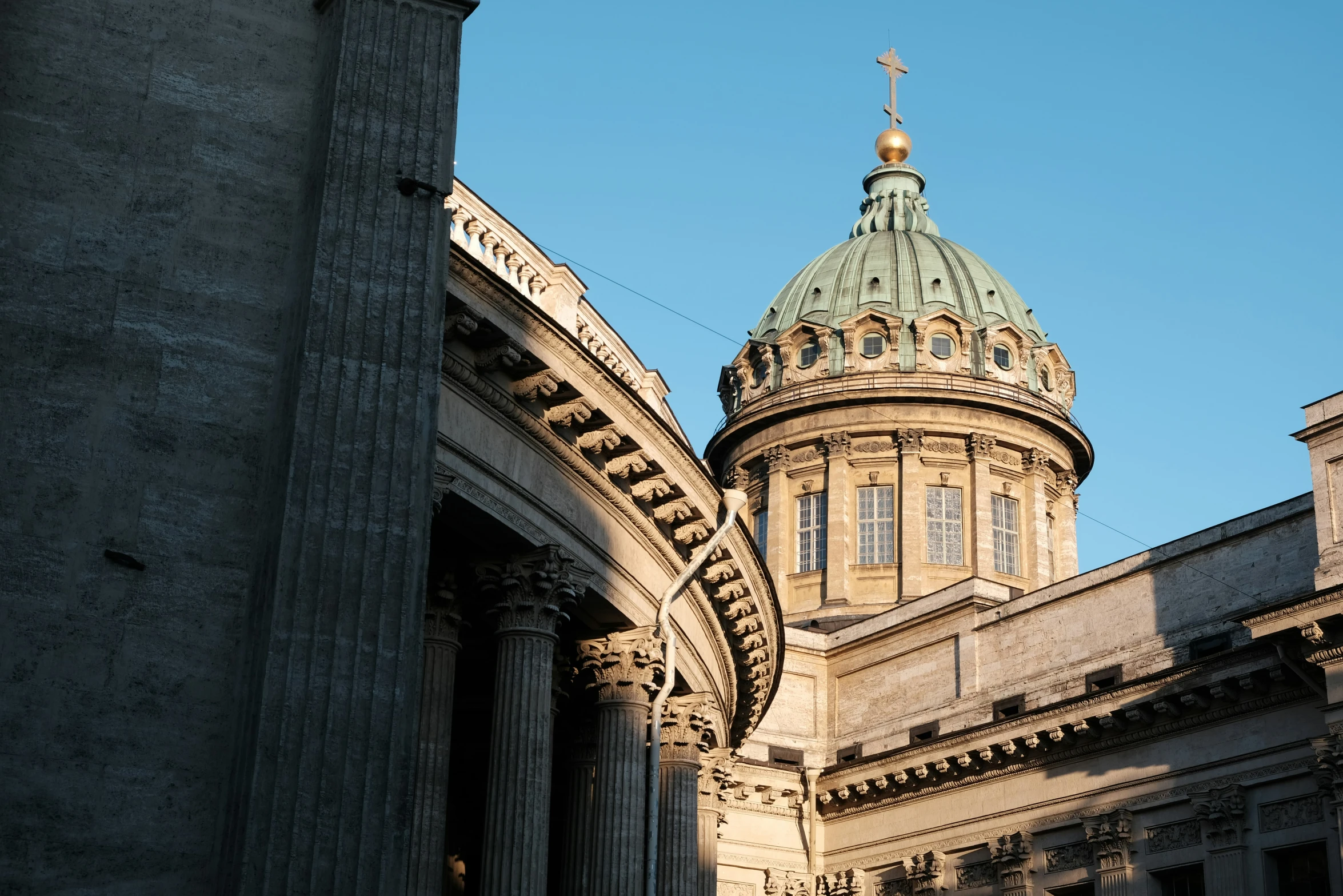 the top of a building with columns and a clock tower