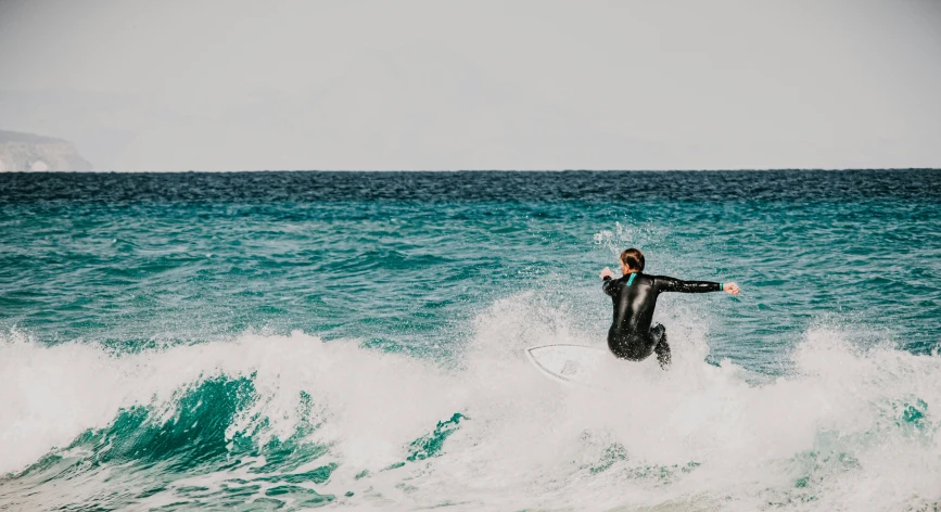 a person riding waves on a surfboard