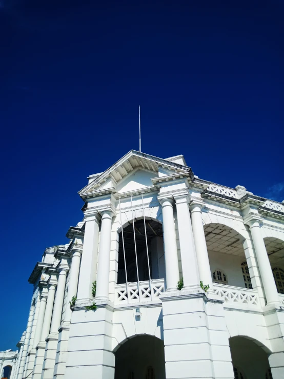 a large white building that has a flag on top