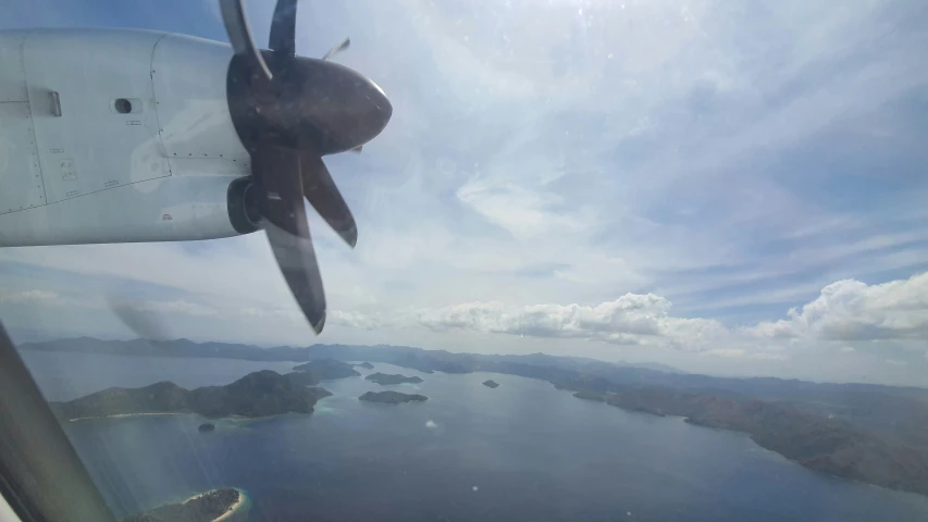 view out the airplane window shows water, and land