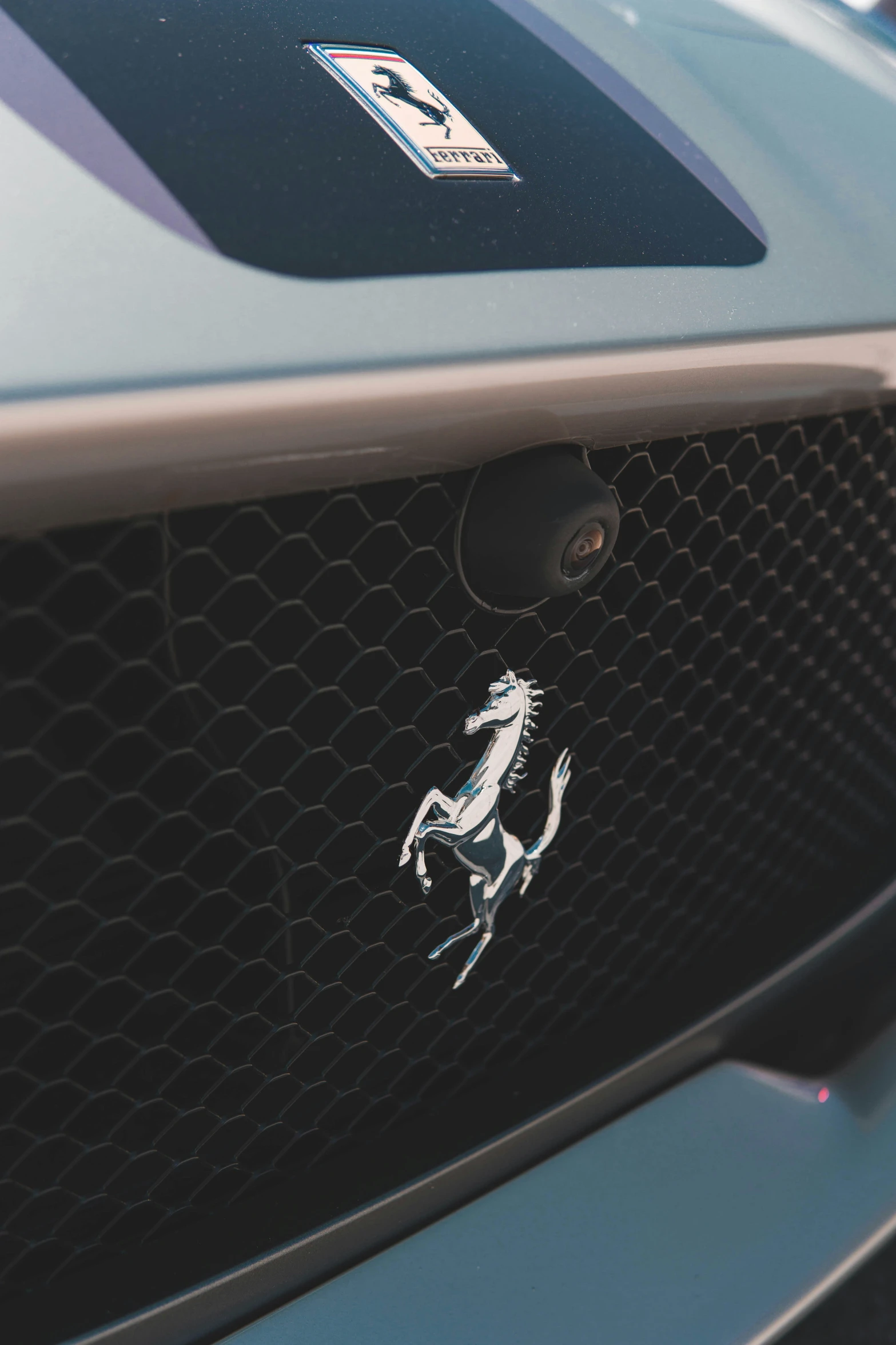 a mustang badge on the front grill of a car