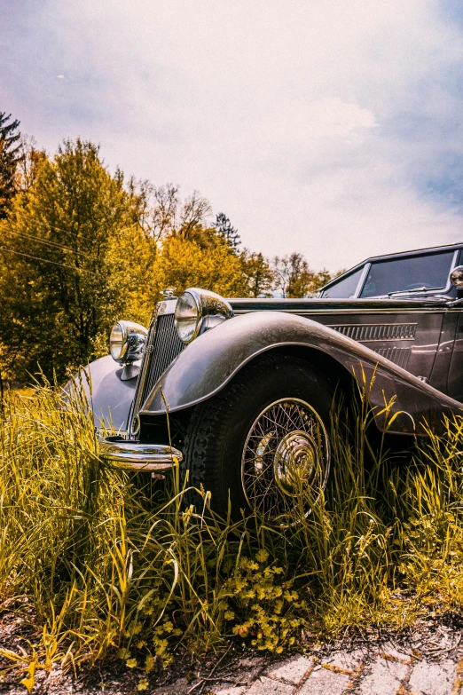 an old, black vintage car parked on the side of the road