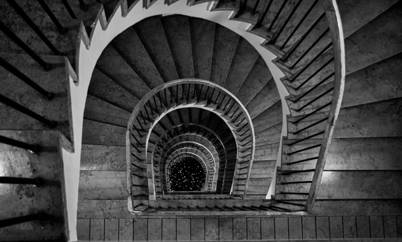 an abstract, swirling staircase made of wood and concrete