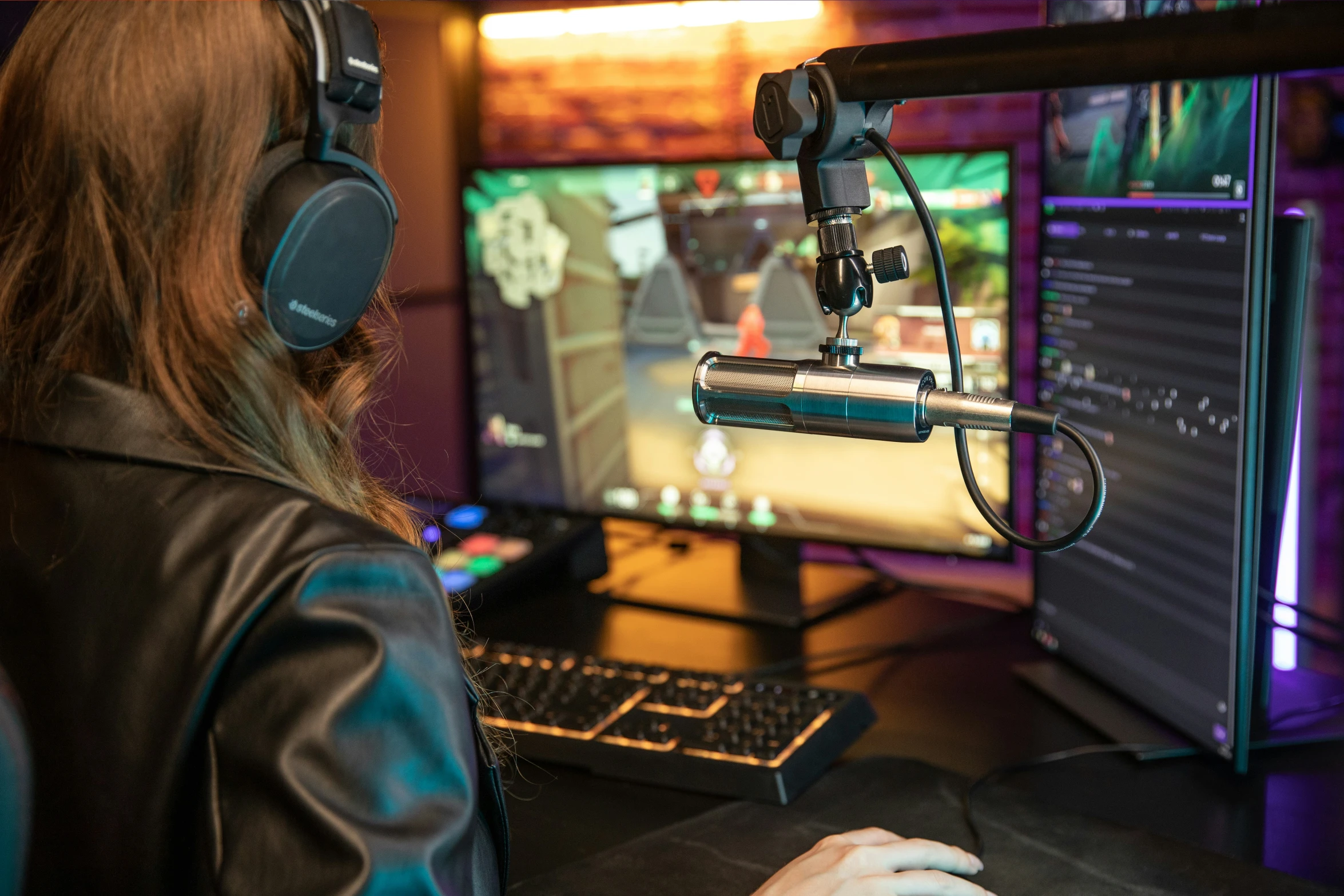 woman using headphones in front of a television