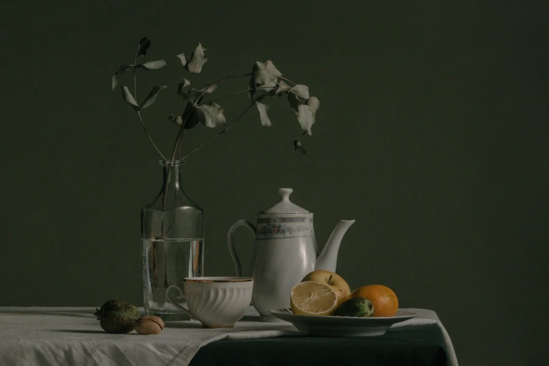 a table with fruits, pitcher and vase on it