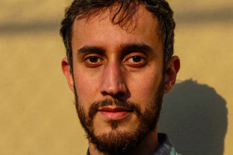 a man with freckles and a goatee in front of him