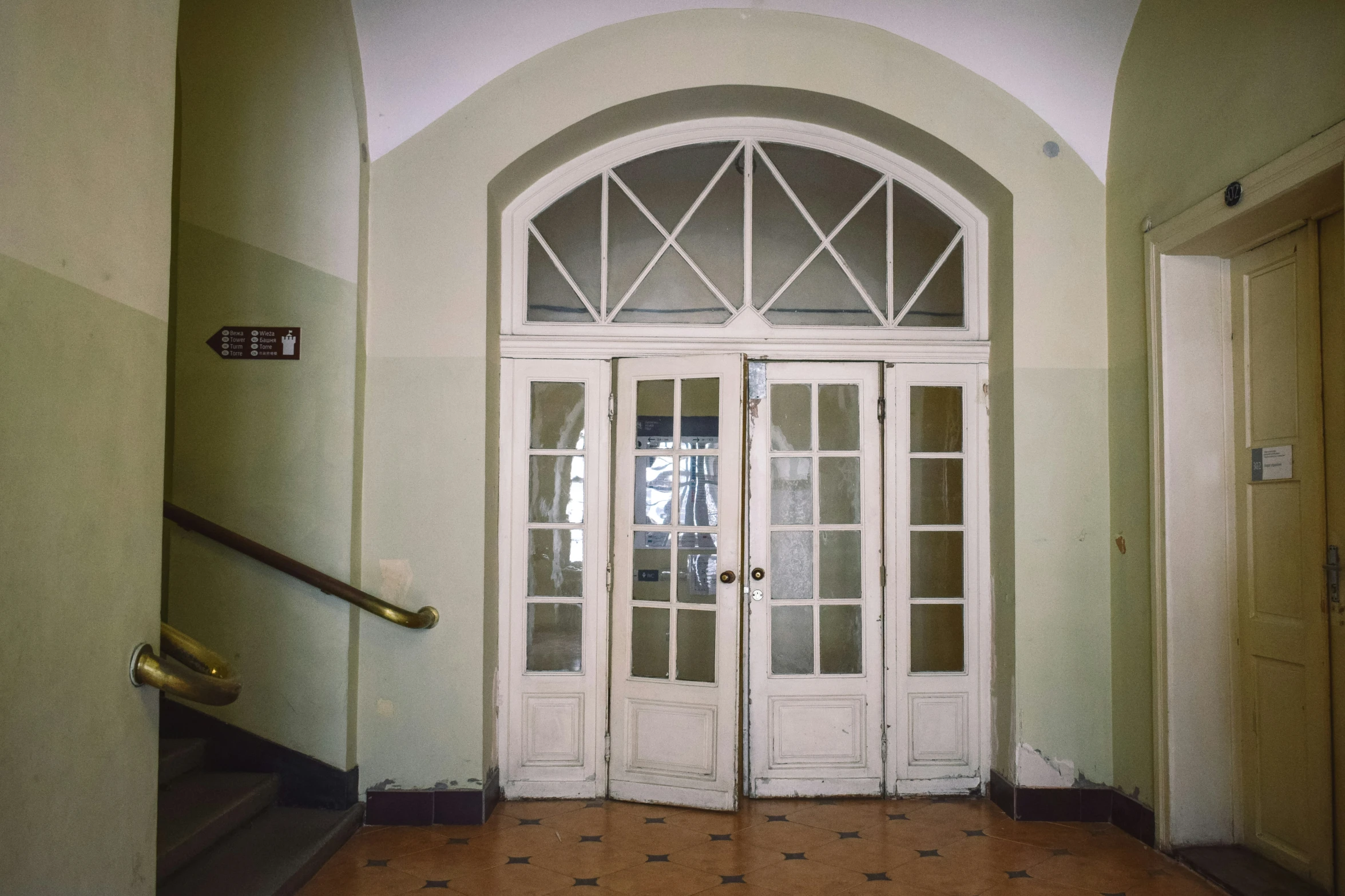 two white double doors with a tiled floor