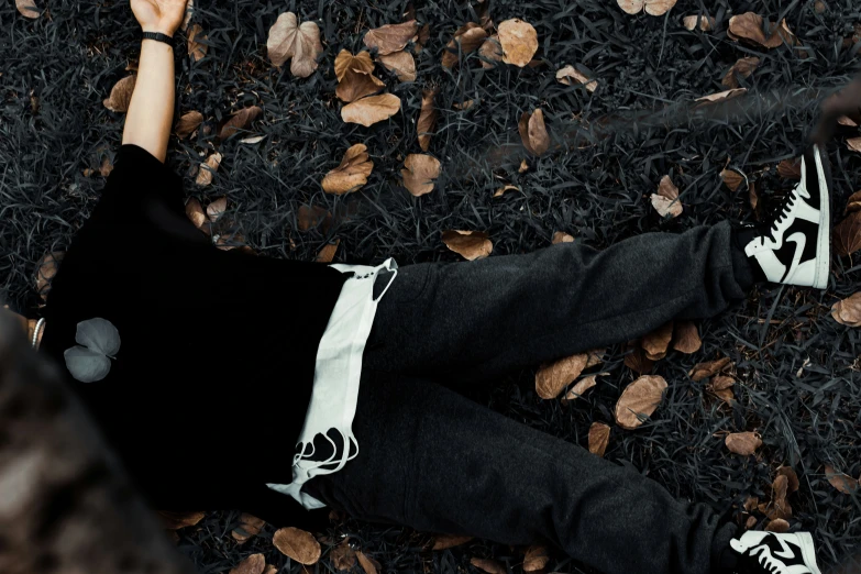 a woman laying on the ground with her arms outstretched