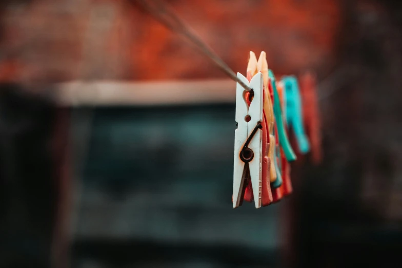 several pairs of scissors hung from a clothes line