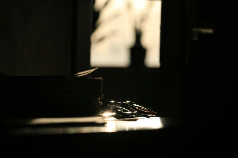 a light shining on the table with a computer mouse in a room