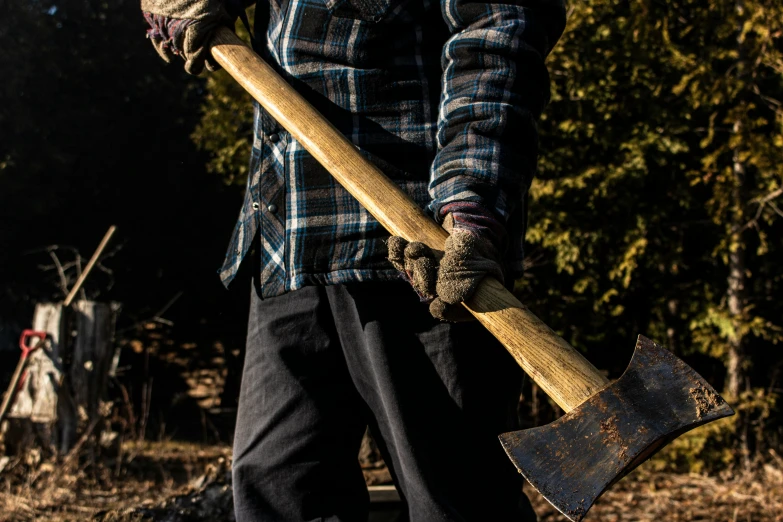 an old man with a large axe and a hat on