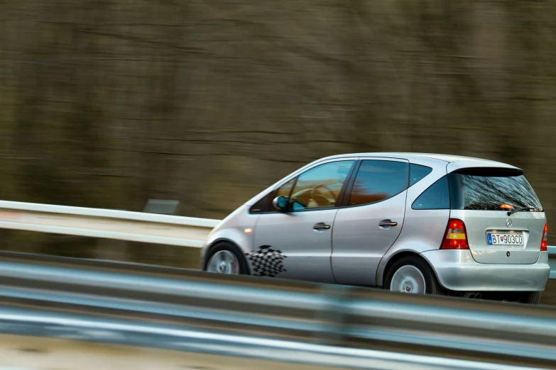 an automobile driving along the road in the country side