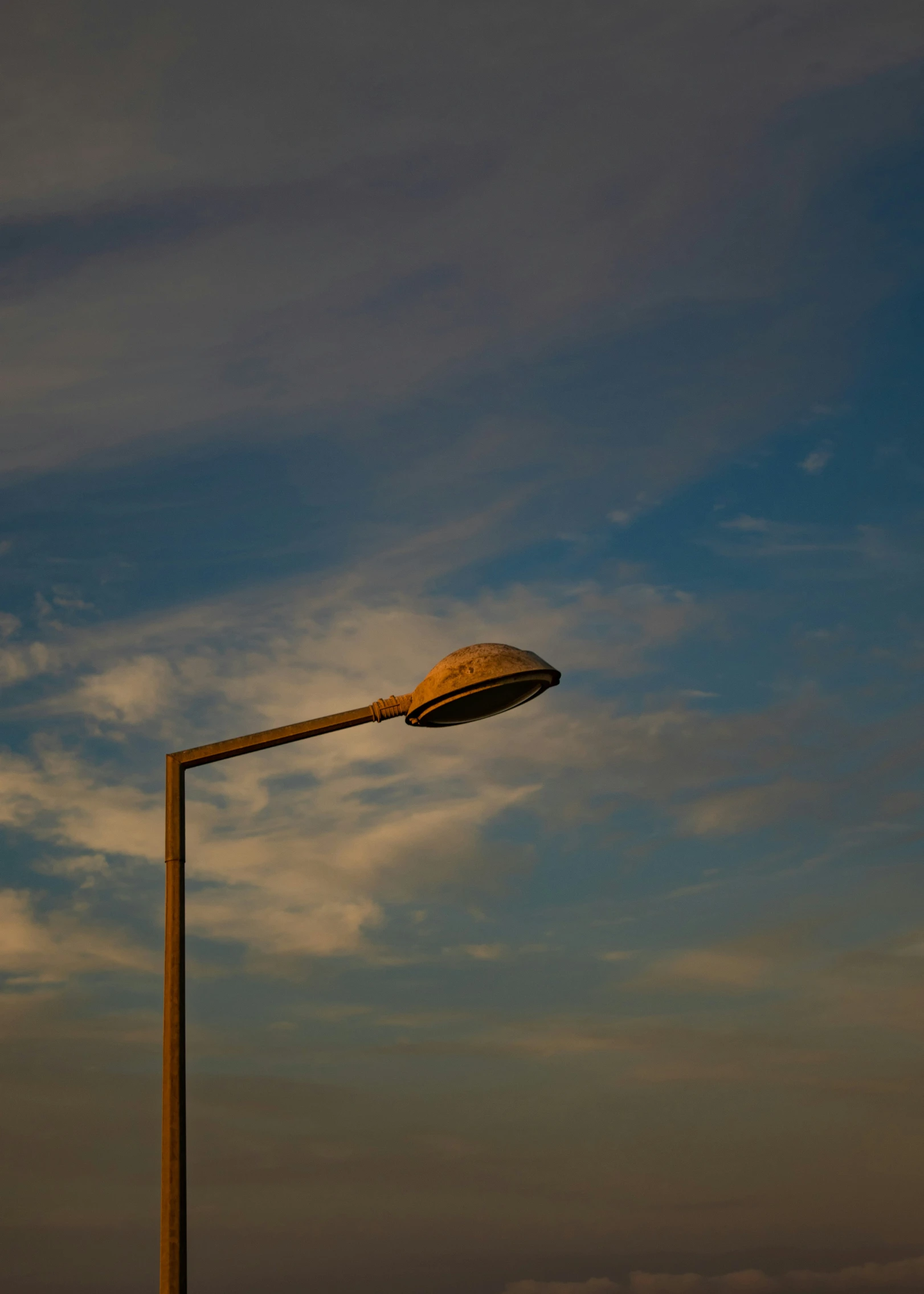 a person on the beach near a lamp