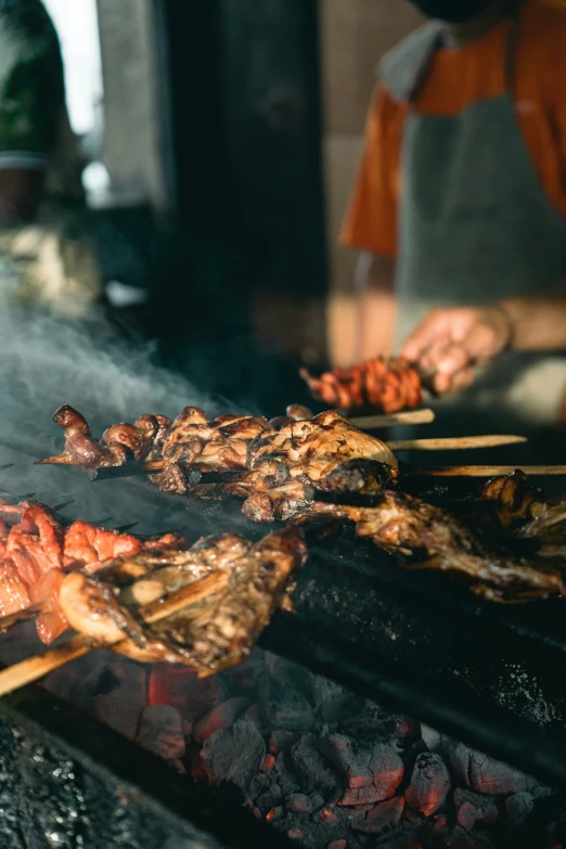 some food is being grilled outside by someone