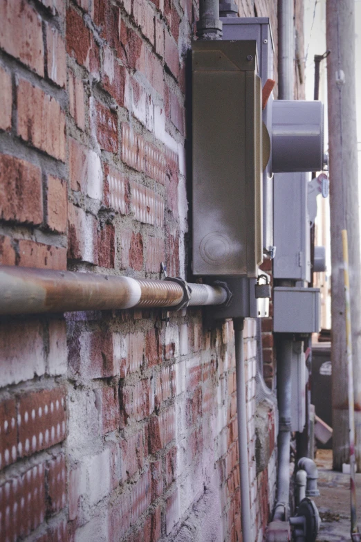 the street lights are attached to the brick wall