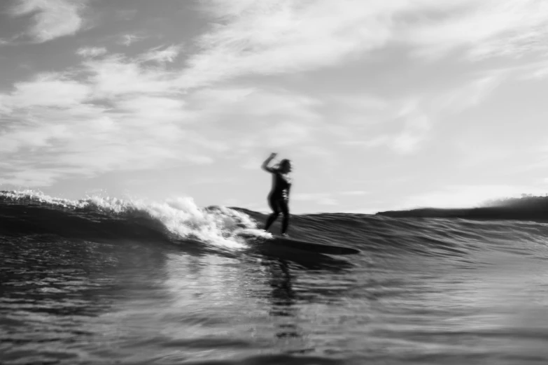 a surfer standing on a surfboard in the ocean