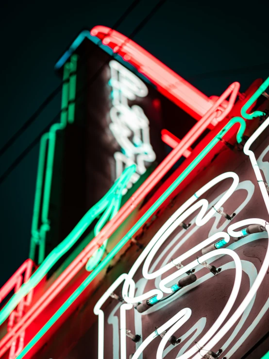 a large neon sign on the side of a building