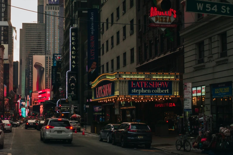 the city streets are very crowded with cars, signs and lights