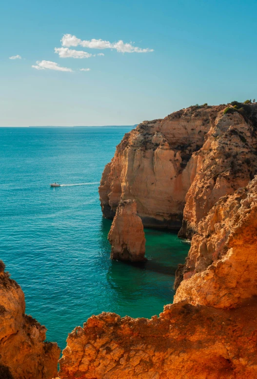 a boat near the shore with two rocks