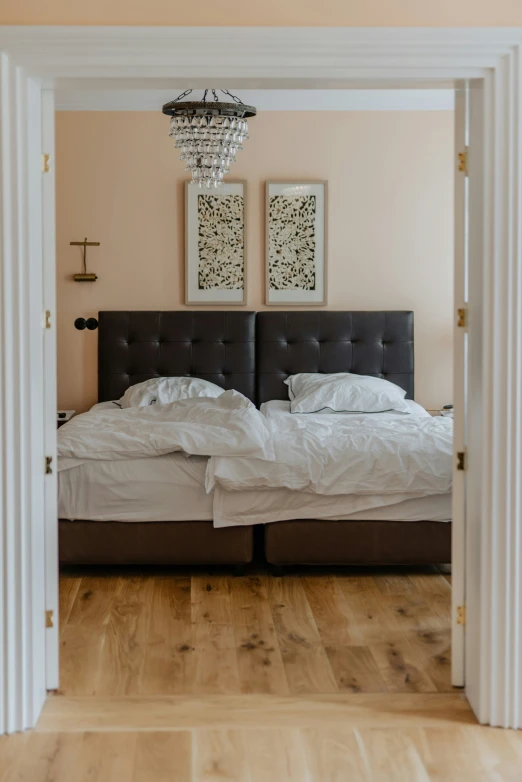 a bed and chandelier in a small room