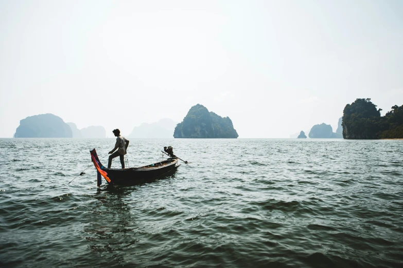 a man on the back of a boat in an ocean