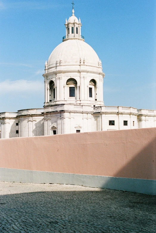 a white dome building with a clock on top