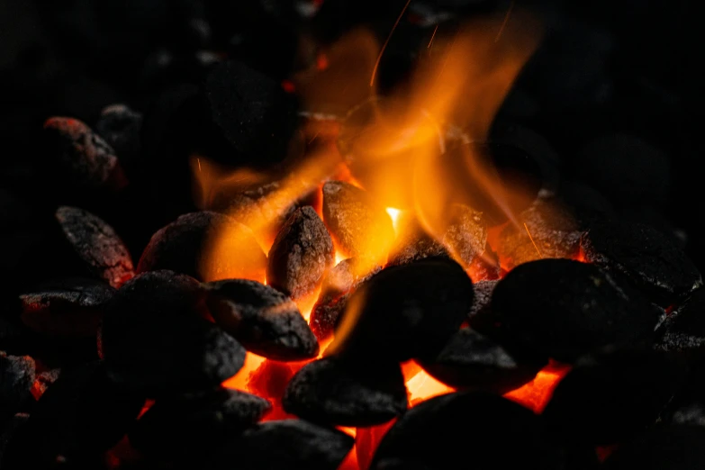 a close up of a fire with coals