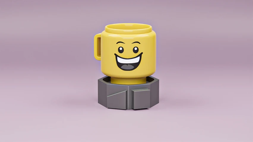 a yellow mug with eyes sitting on top of a box