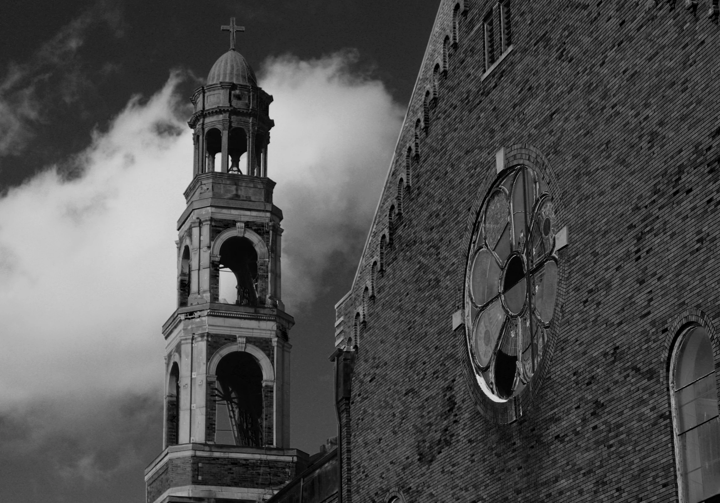 the clock on the side of a building next to clouds